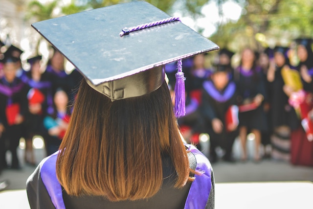 Girl at graduation with her graduation cap and tassle.