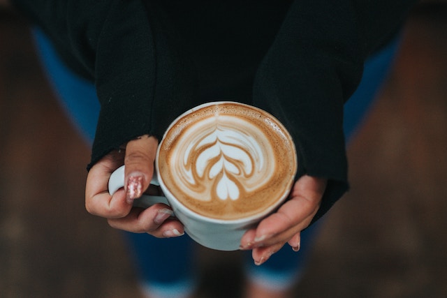 Coffee Mug in a girl's hands.