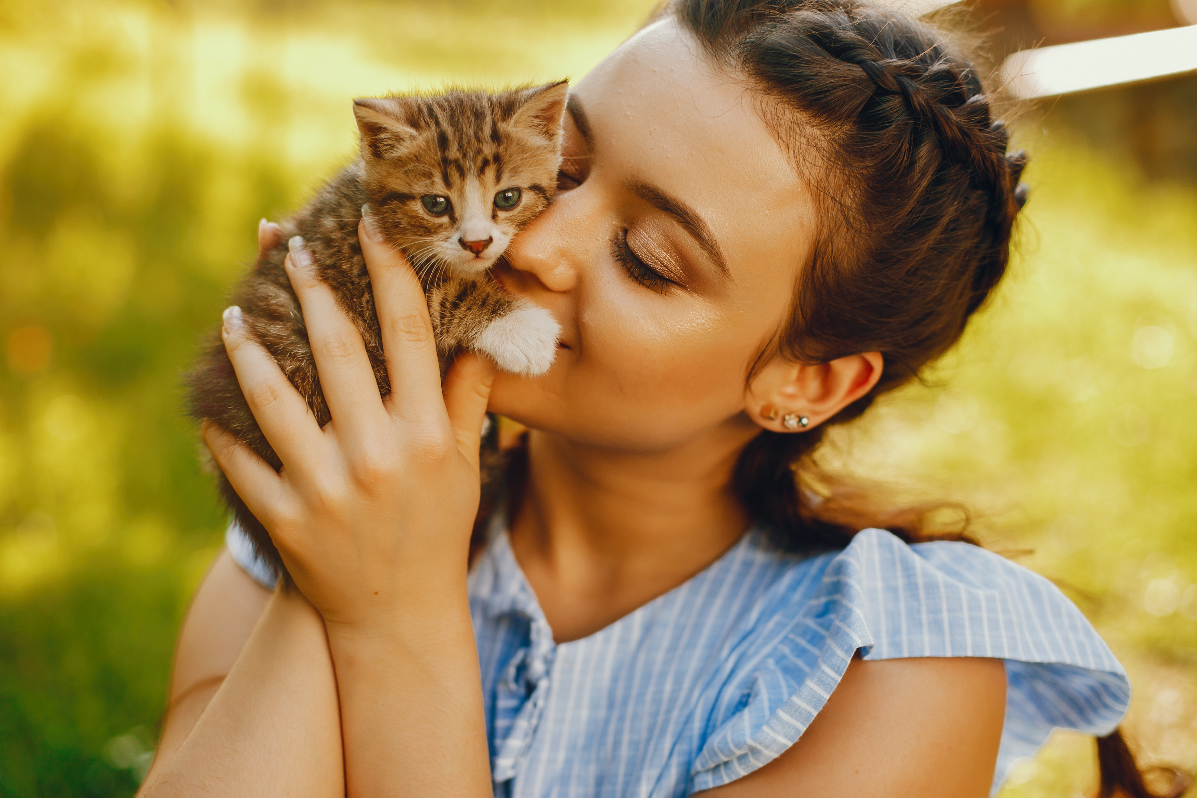 woman playing with a small kitten.