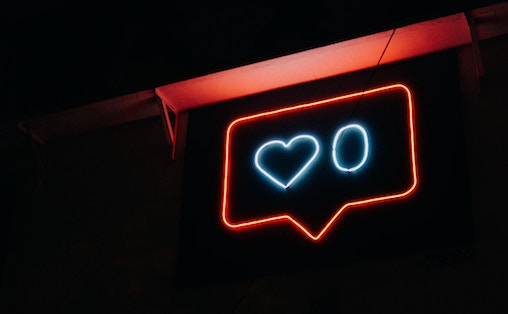 a neon sign showing zero like count.