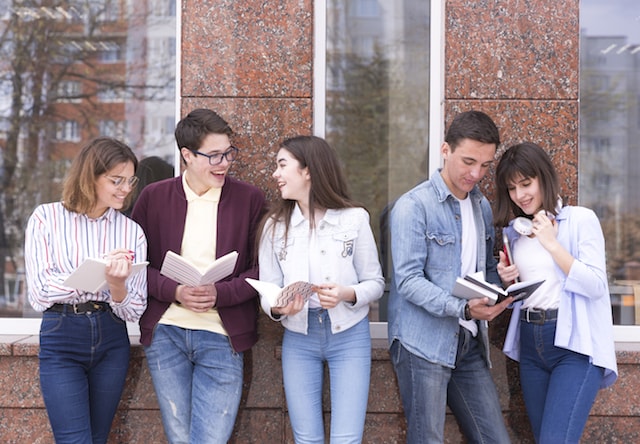 students and friends all with books and smiling together.