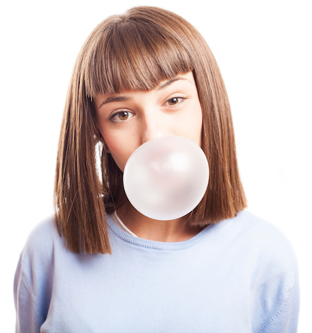 girl blowing a bubble gum to reduce stress.