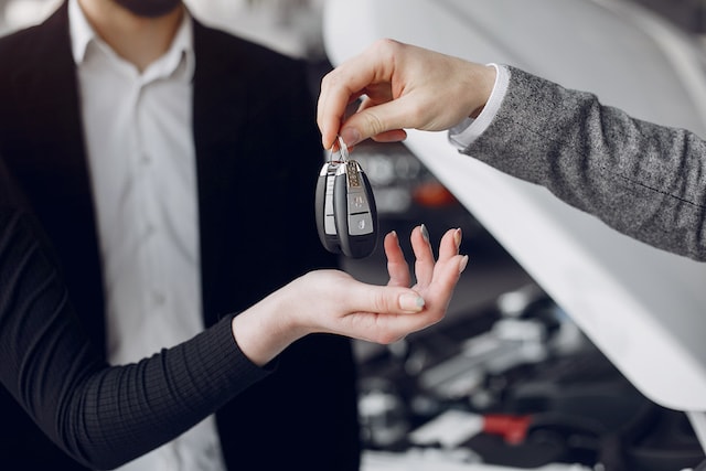 handing over car keys for a rental, which has hidden fees.