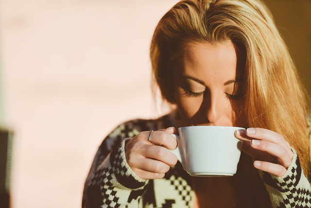 woman drinking a cup of coffee in. the morning. 